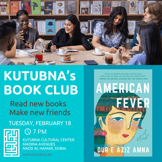 a group of people sitting around a table with a book reading a book.