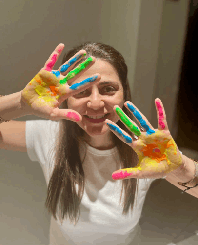 a woman with her hands covered in paint.